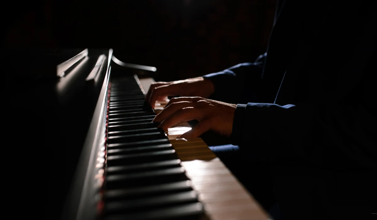 40 amazing Cute Date Ideas in Columbus, Ohio for Couples in 2025 9 Hands playing a piano in a dimly lit setting, highlighting the keys and the musician's fingers. The scene conveys a sense of focus and musical expression.