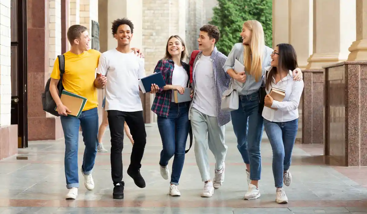 Top 15+ Free Things to do in Atlanta for Couples 2025 7 Six happy students walk together on a campus, holding books and backpacks. They are smiling and casually dressed, with their arms linked around each other. The building has columns and brick walls, suggesting a university setting.