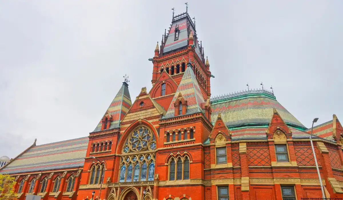 15 Free Romantic Things to Do in Massachusetts for Couples 14 A historic building with intricate red brickwork and multicolored slate roofing, featuring an ornate tower and arched stained glass windows under a cloudy sky.