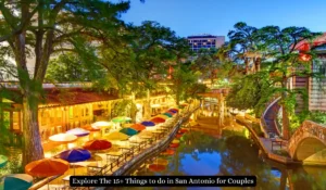 Scenic view of San Antonios River Walk at dusk, featuring brightly colored umbrellas lining the riverside cafes and restaurants, with lush green trees and warm, inviting lights reflecting on the water. "Things to do in San Antonio for Couples"