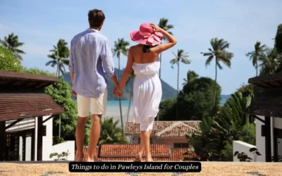 15 Top Things to do in Pawleys Island for Couples 2024 A couple holding hands, facing towards a tropical view with palm trees and the ocean. The woman wears a pink sunhat and white dress, while the man is in a light shirt and shorts. The text reads, Things to do in Pawleys Island for Couples.