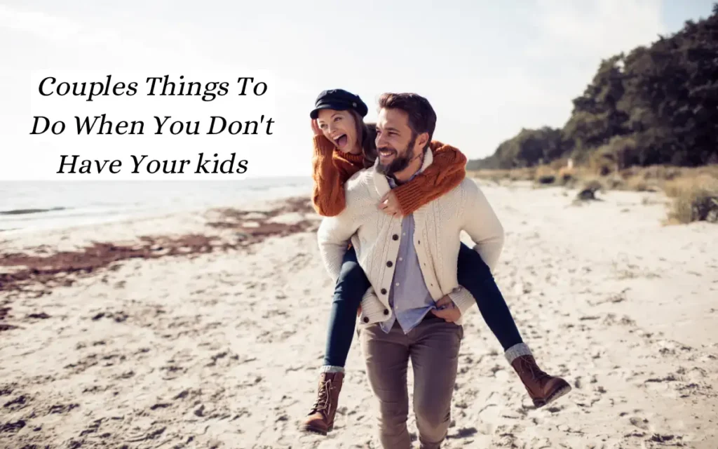 Top 10+ Couples Things To Do When You Don't Have Your kids 2 A smiling man carrying a joyful woman on his back along a sandy beach. Both are dressed warmly, enjoying a sunny day. The text reads, Couples Things To Do When You Don't Have Your Kids. Trees and the sea are visible in the background.