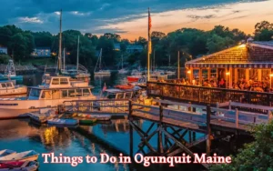 A vibrant evening scene at a marina in Ogunquit, Maine. Boats are docked by a wooden pier, and a restaurant with glowing lights is bustling with people. Things to Do in Ogunquit Maine