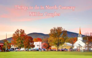 A scenic view of North Conway, NH during autumn. Vibrant fall foliage with red and orange trees surround a small town with a church and mountains in the background. Text reads: Things to do in North Conway NH for Couples.