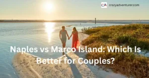 A couple holding hands walks along a sandy beach at sunset, with sunlight reflecting on the water. Text reads, Naples vs Marco Island: Which Is Better for Couples?.